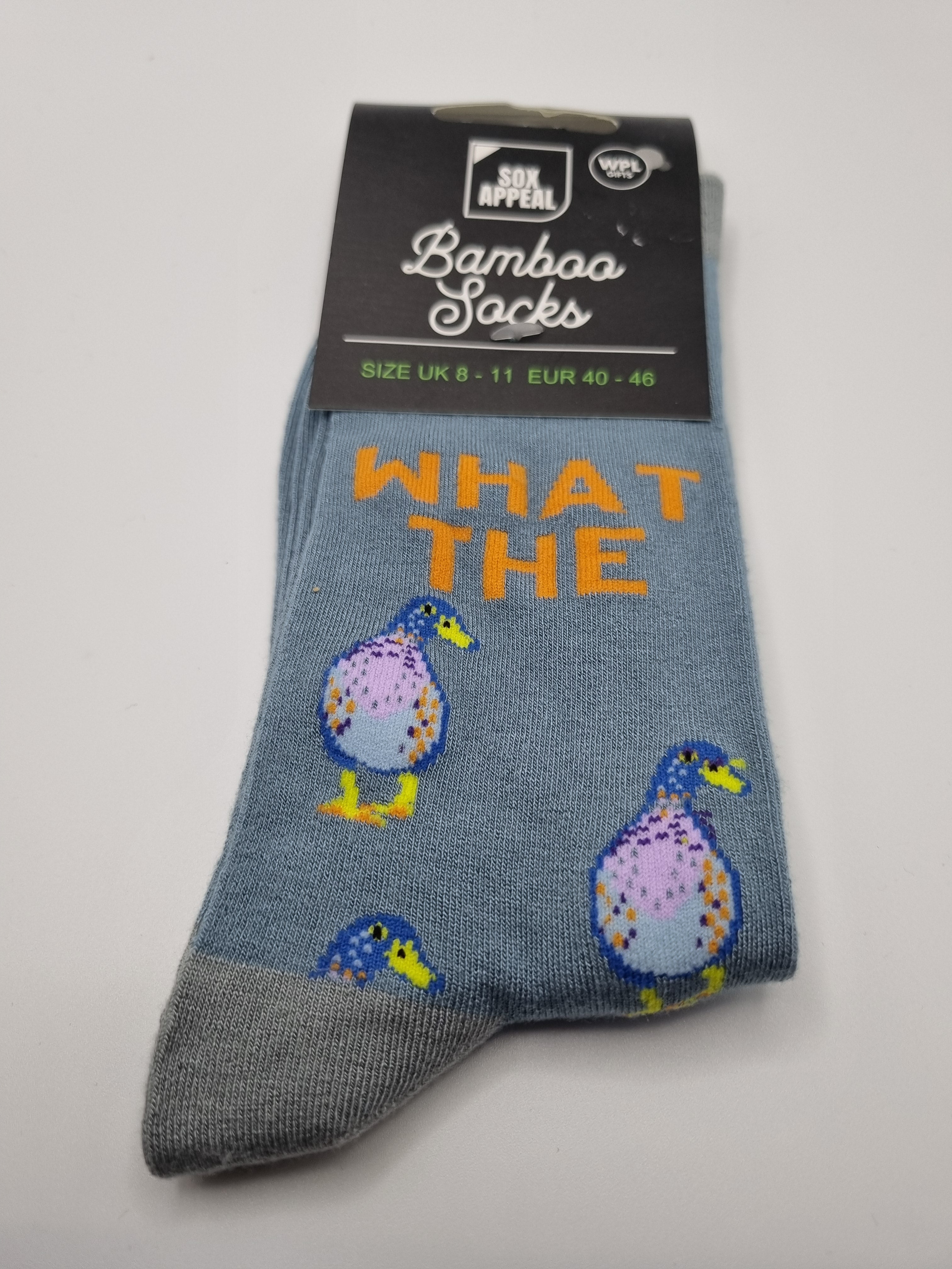 Blue What The Duck novelty men's bamboo socks with orange text and cartoon duck illustrations, grey cuffs and toes, UK size 8–11, shown in packaging