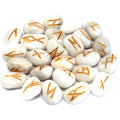 White agate rune stone set featuring engraved symbols on polished white gemstone pieces used for divination and spiritual practices.