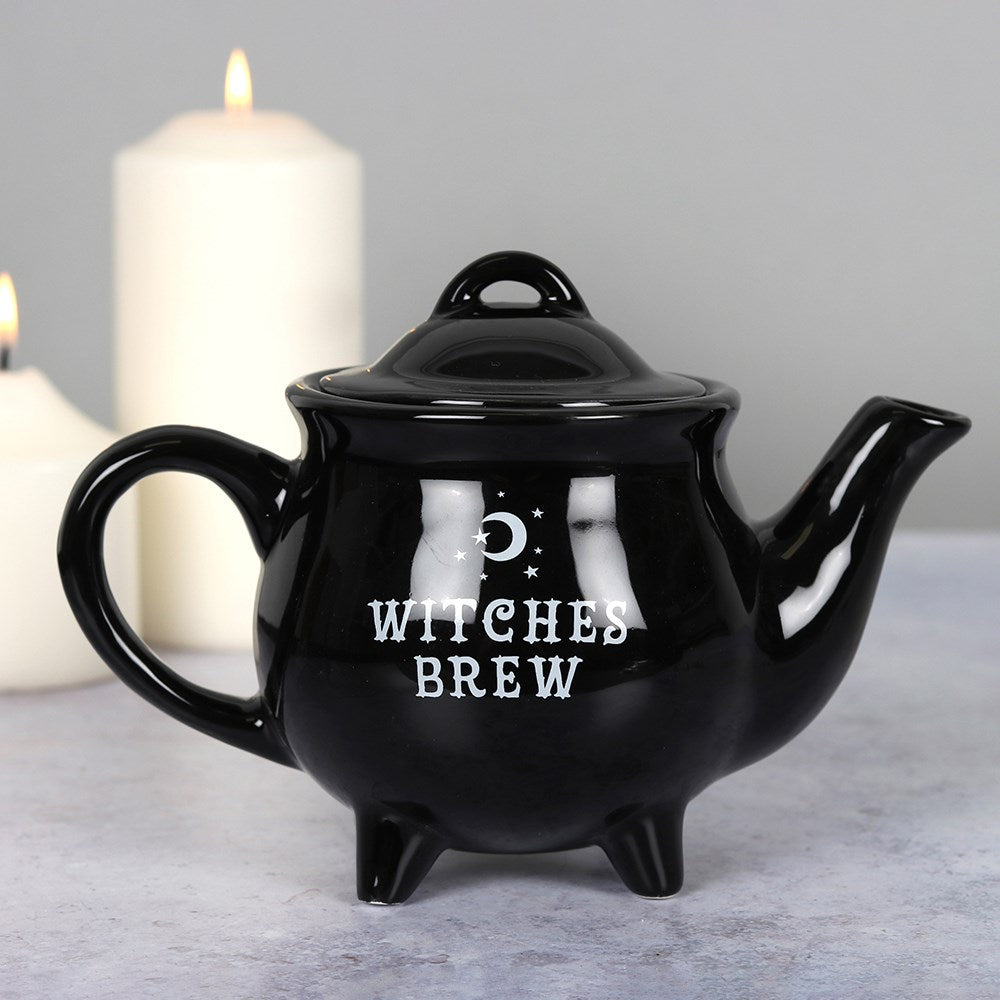 Black ceramic teapot featuring “Witches Brew” text with gothic witch-inspired decorative design.