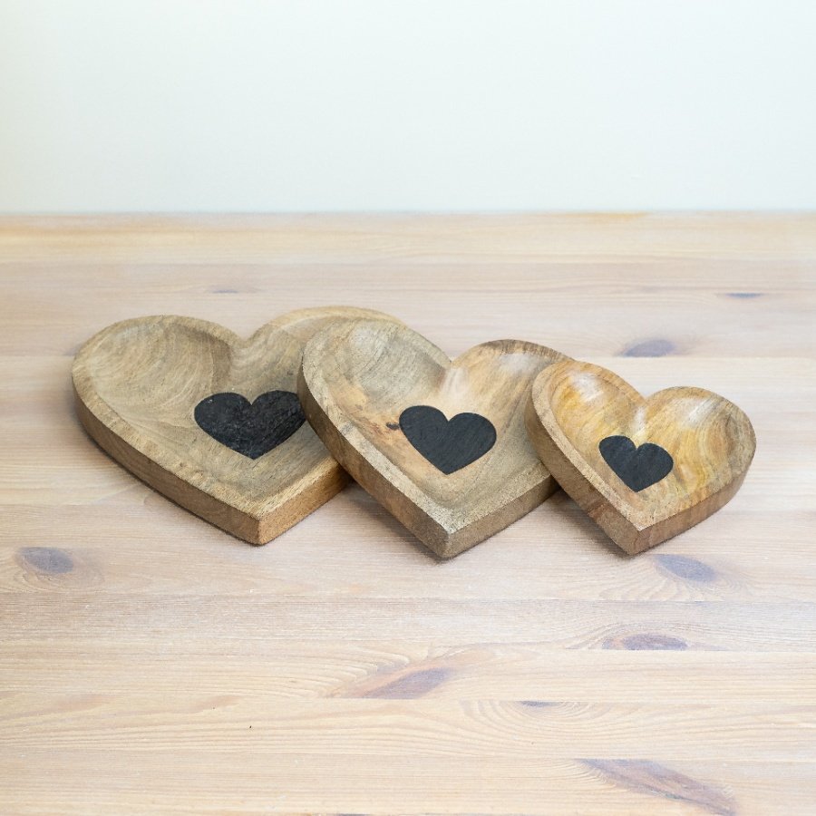 Three natural wood heart-shaped trays in different sizes, each featuring a black heart detail and rustic wooden finish.